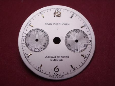 Valjoux 69, Chronographen-Zifferblatt, Ø 24,3mm, Metall weiß mit gelben Indikationen, Beschriftung: JEAN ZURBUCHEN LA CHAUX-DE FONDS SUISSE SWISS MADE 