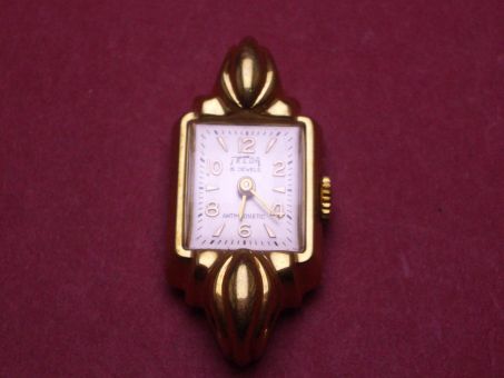 Komplette Uhr von Telda, Messing, vergoldet, 16mm x 35,7mm, weißes Zifferblatt mit goldfarbenen Indikatoren, Gehäuseboden aus Stahl 